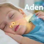 A young child sleeping peacefully under a soft blue blanket, illustrating healthy breathing and recovery from Adenoidid.
